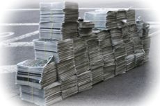 Piles of newspapers on the curbside